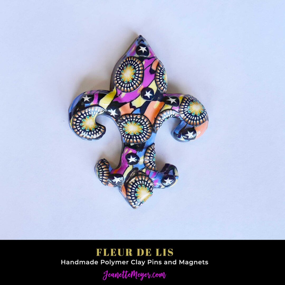 Handmade polymer clay fleur-de-lis pin by New Orleans artist Jeanette Meyer. A colorful, collectible design available as both pins and magnets.