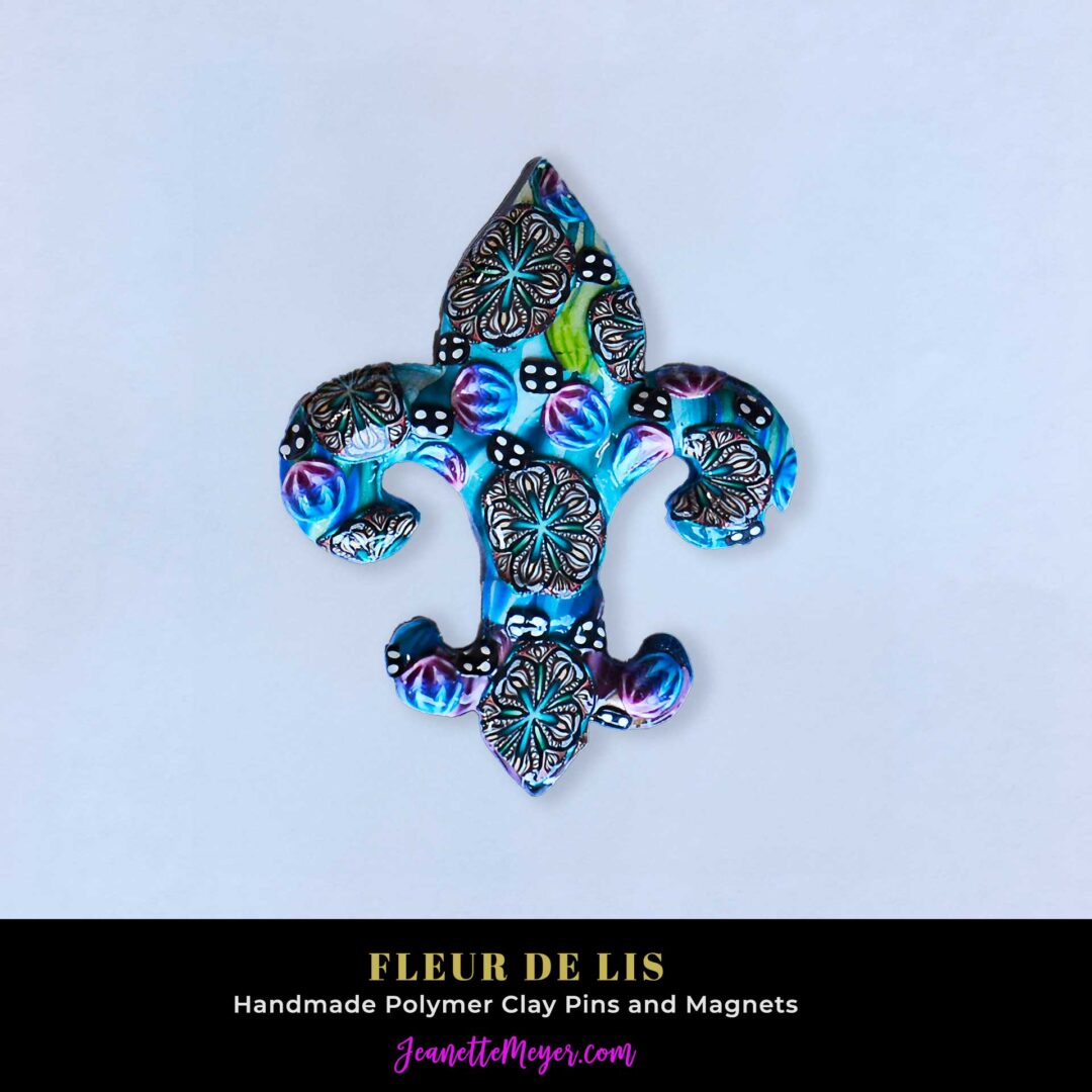 Handmade polymer clay fleur-de-lis pin by New Orleans artist Jeanette Meyer. A colorful, collectible design available as both pins and magnets.
