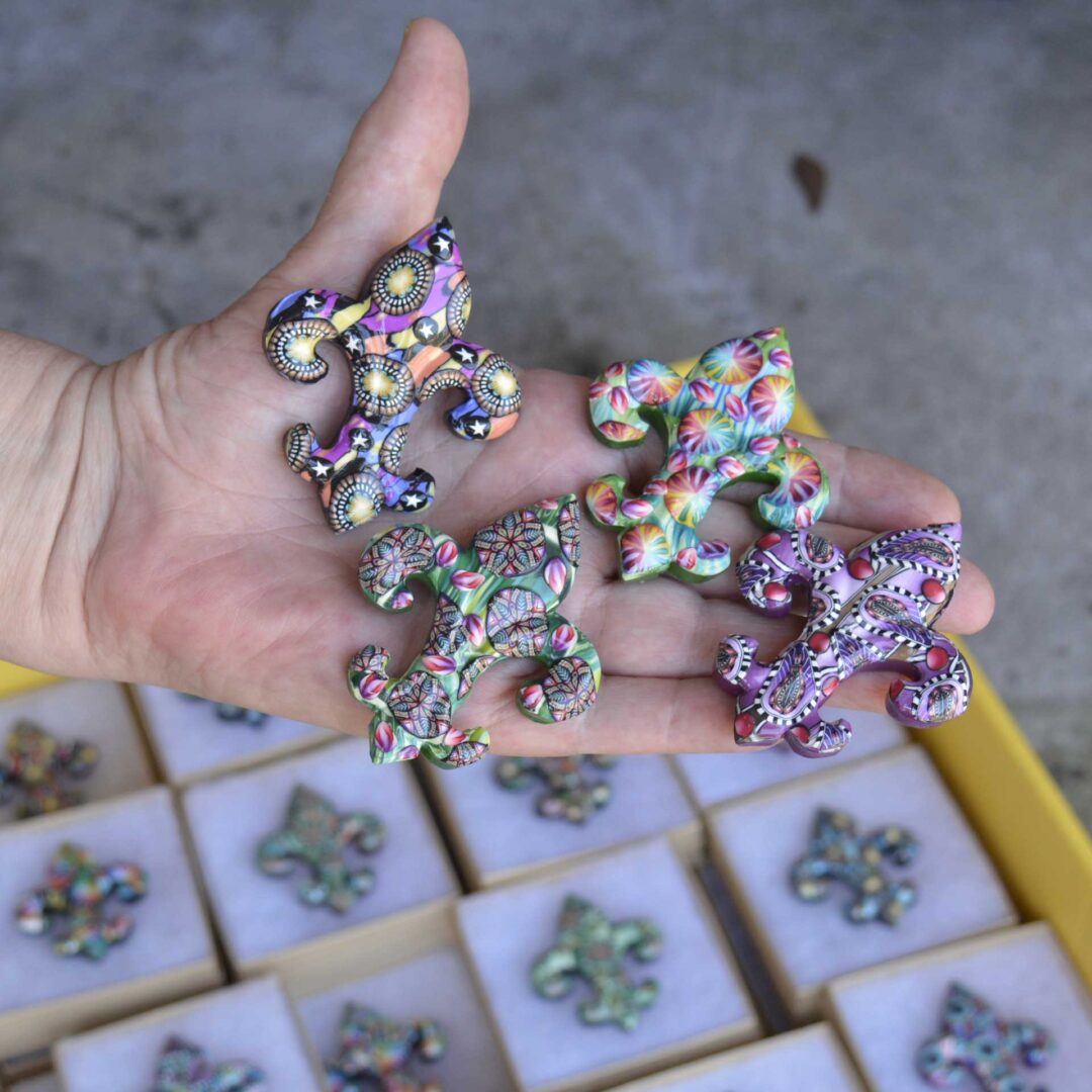 Handmade polymer clay fleur-de-lis pin by New Orleans artist Jeanette Meyer. A colorful, collectible design available as both pins and magnets.