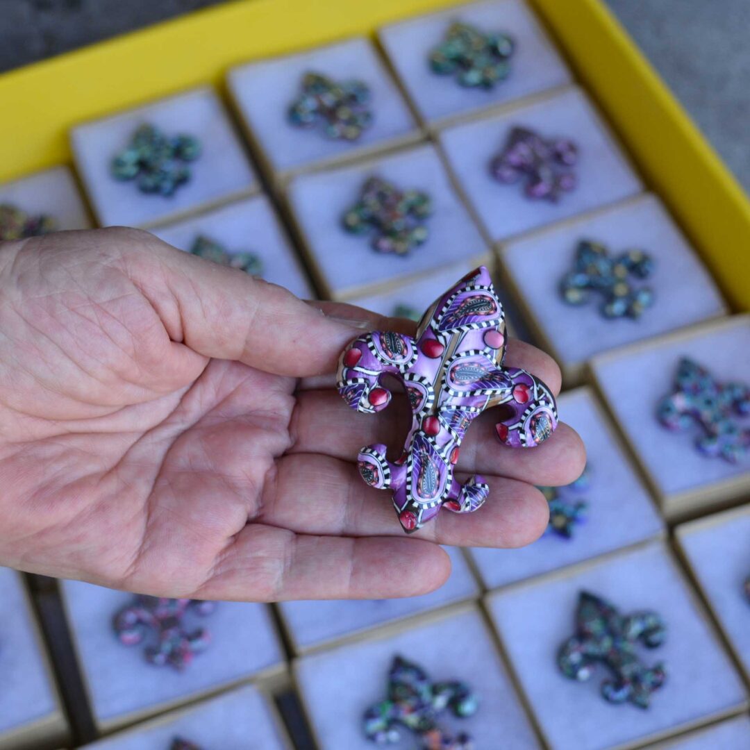 Handmade polymer clay fleur-de-lis pin by New Orleans artist Jeanette Meyer. A colorful, collectible design available as both pins and magnets.