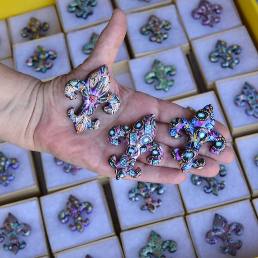 Handmade polymer clay fleur-de-lis pin by New Orleans artist Jeanette Meyer. A colorful, collectible design available as both pins and magnets.